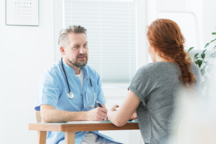 female talking with the doctor in the table