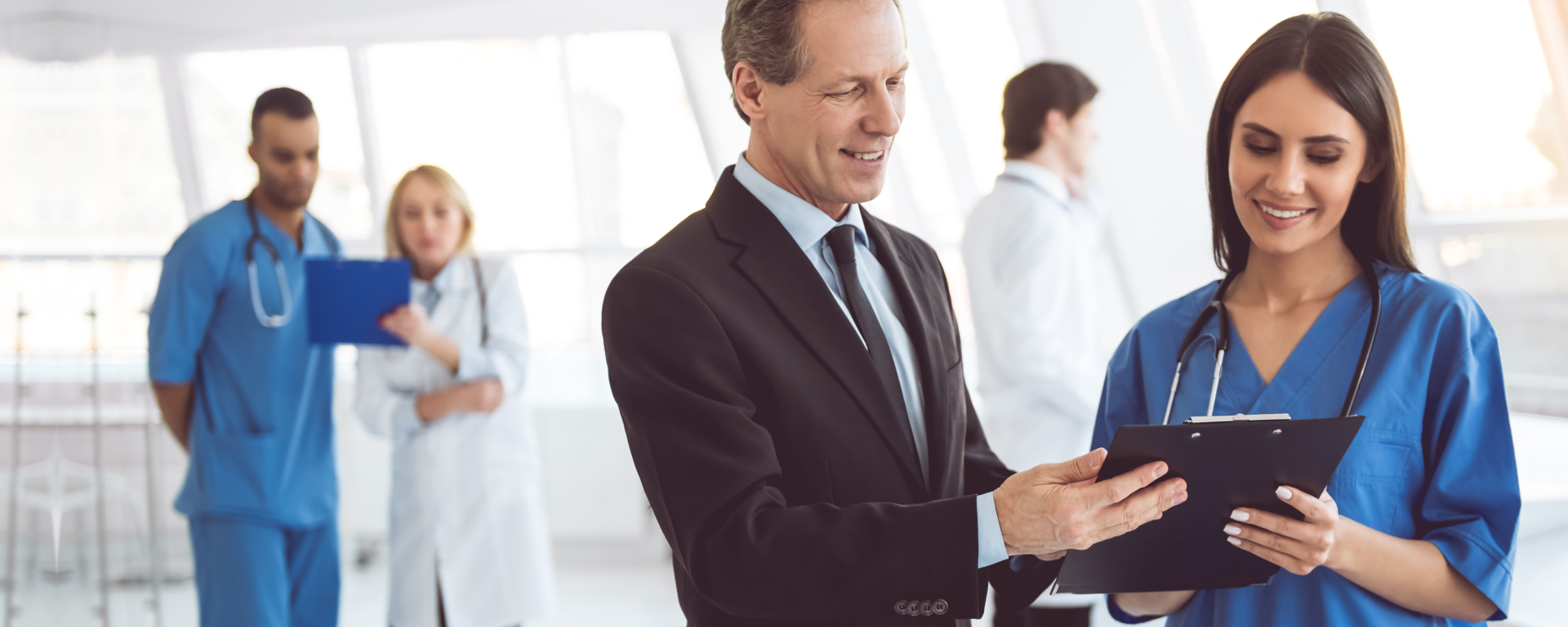 nurse and man wearing talking while checking the reciept