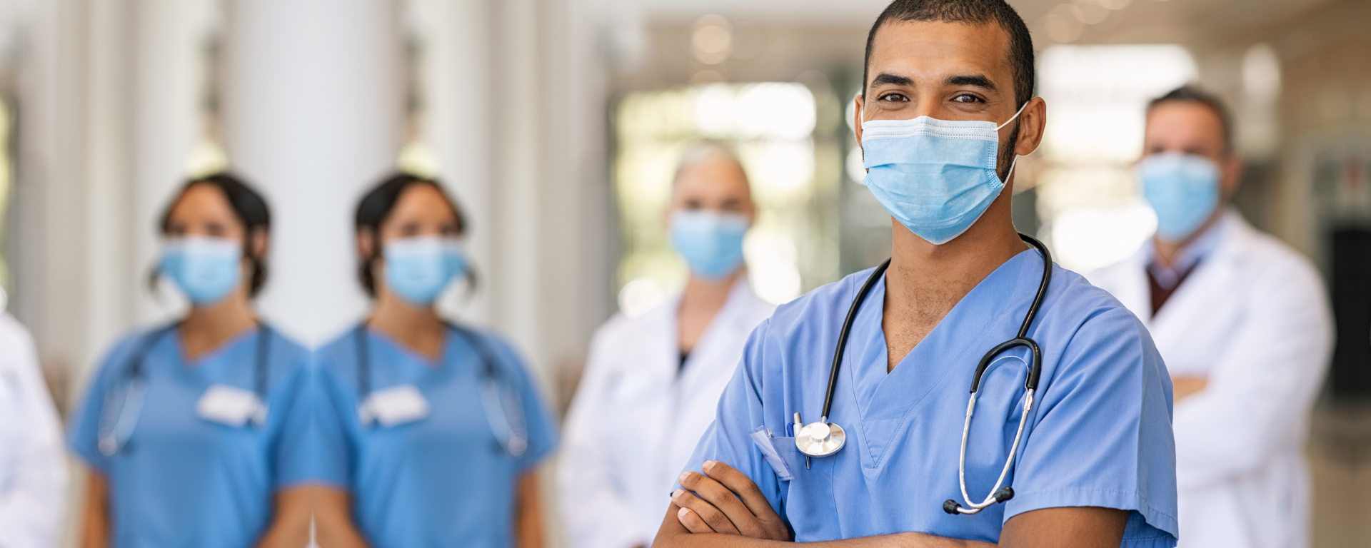 a group of nurses and doctors standing proudly